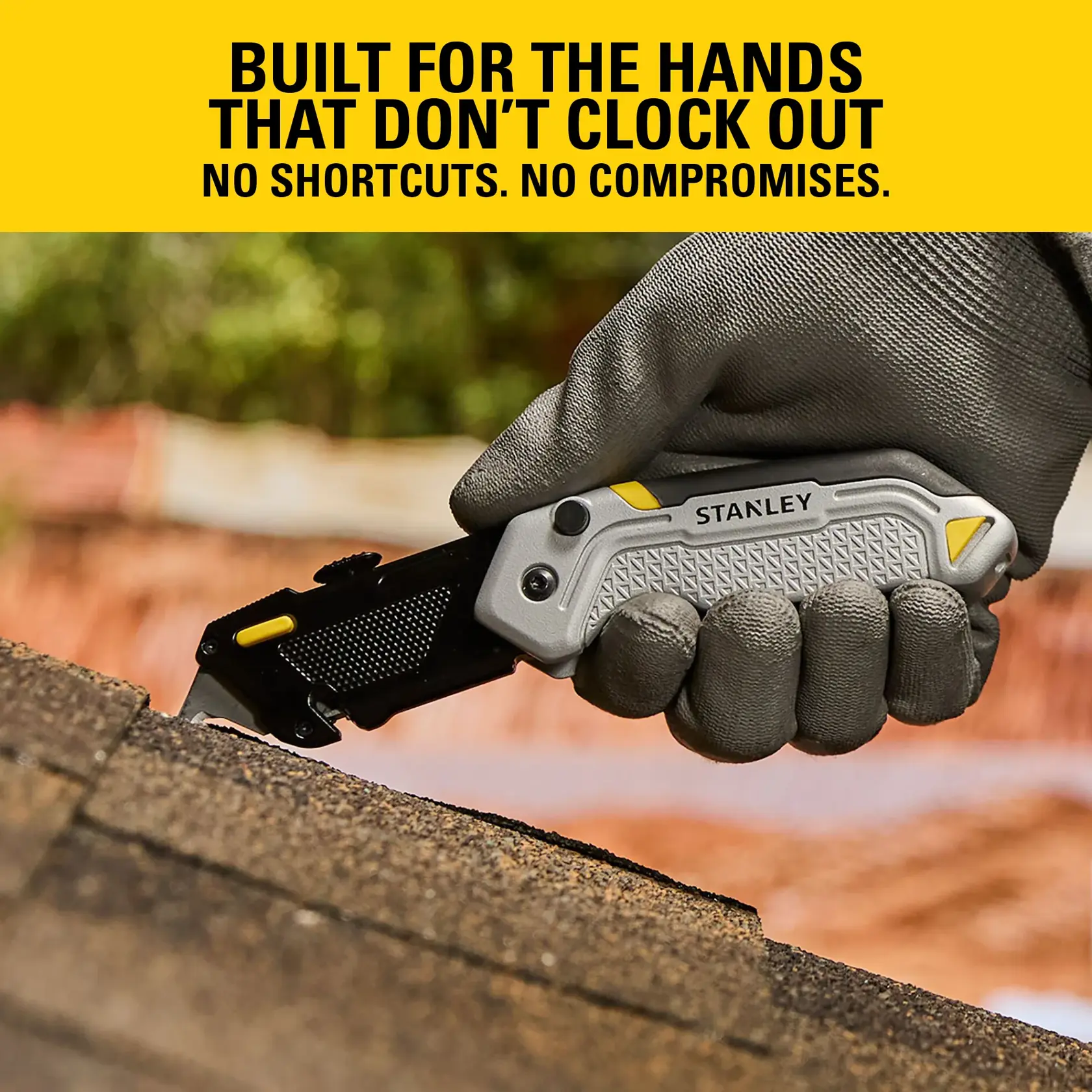 Gloved hand holding a STANLEY folding utility knife, cutting roof shingles outdoors.
