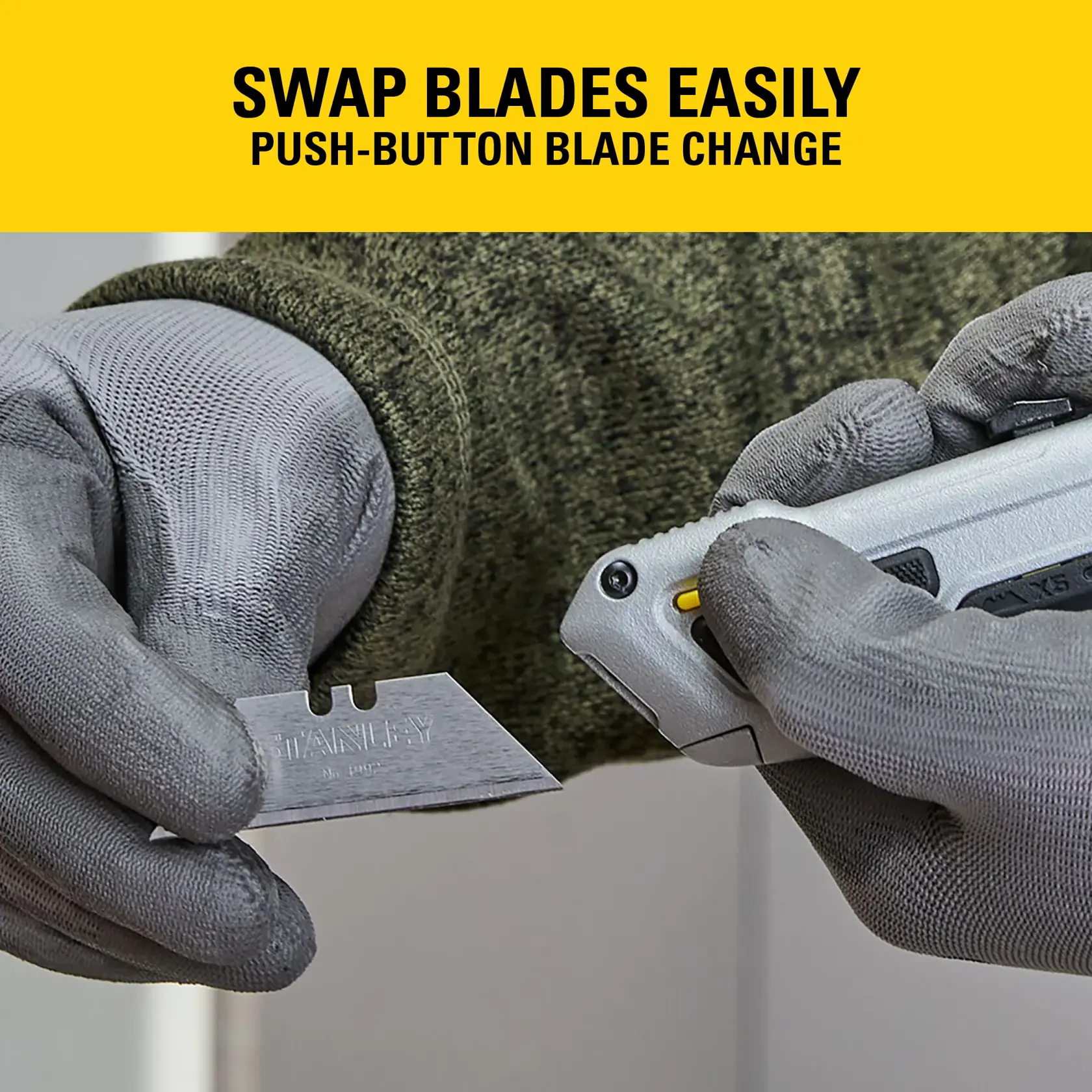 Gloved hands swap STANLEY knife blade with push-button mechanism, showing easy blade change feature.