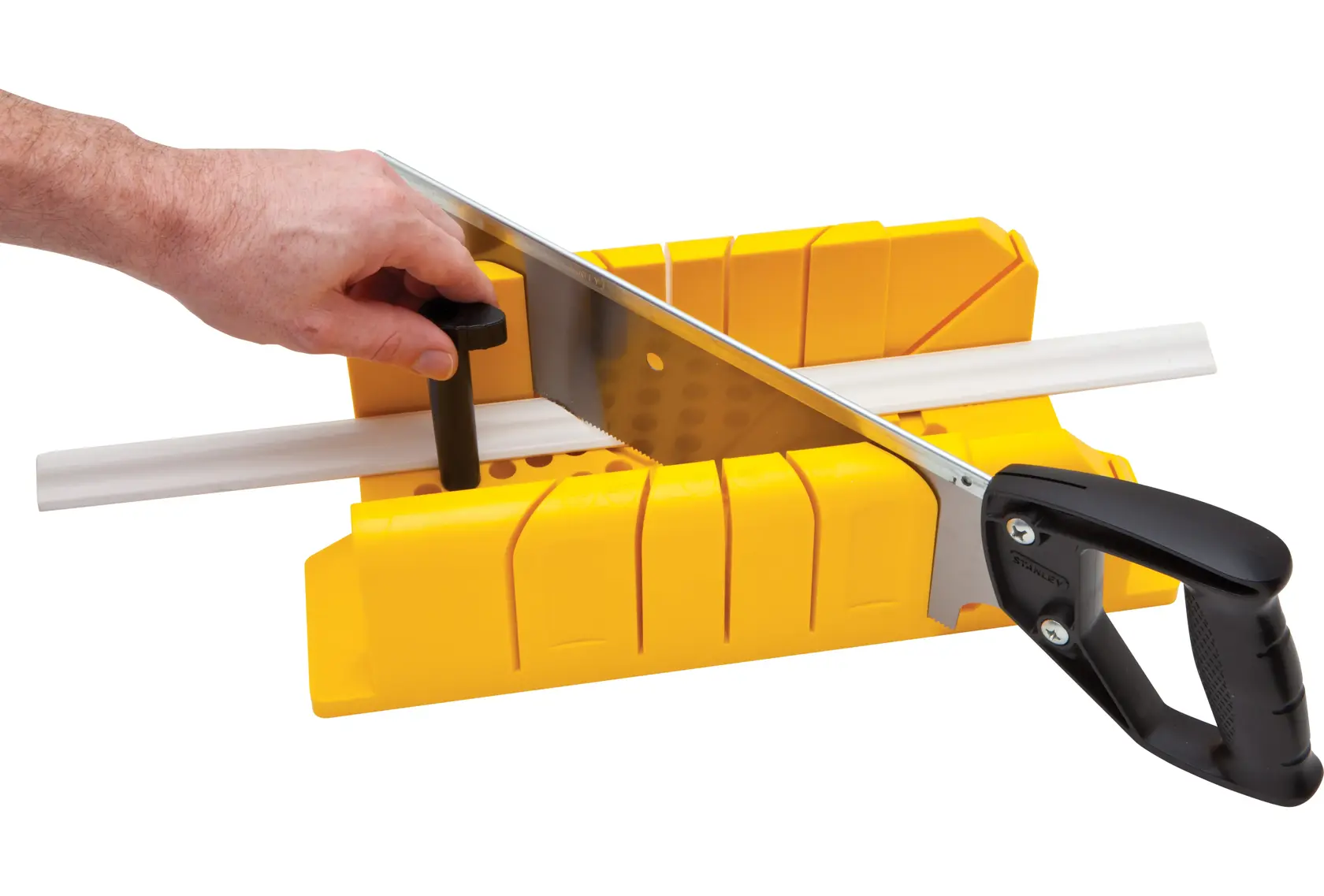 STANLEY 20-600 saw and yellow miter box cutting white molding, photography, side angle.
