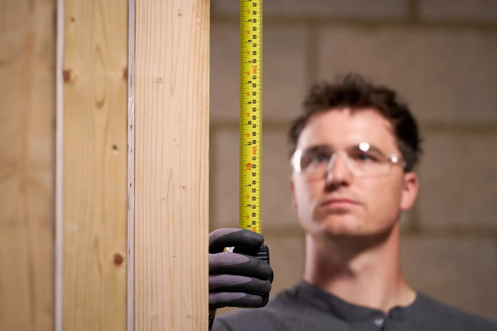 STANLEY 33-731 tape measure measuring wood studs, product in use, photography.