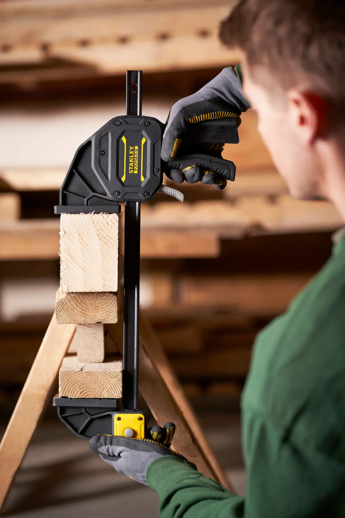 STANLEY FMHT0-83239 photography of quick grip clamp securing wooden blocks in workshop.