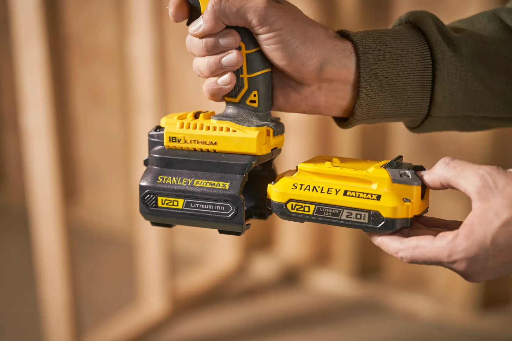 Photo of STANLEY FATMAX V20 lithium ion batteries, SKU SFMCB100, being attached to a power tool.