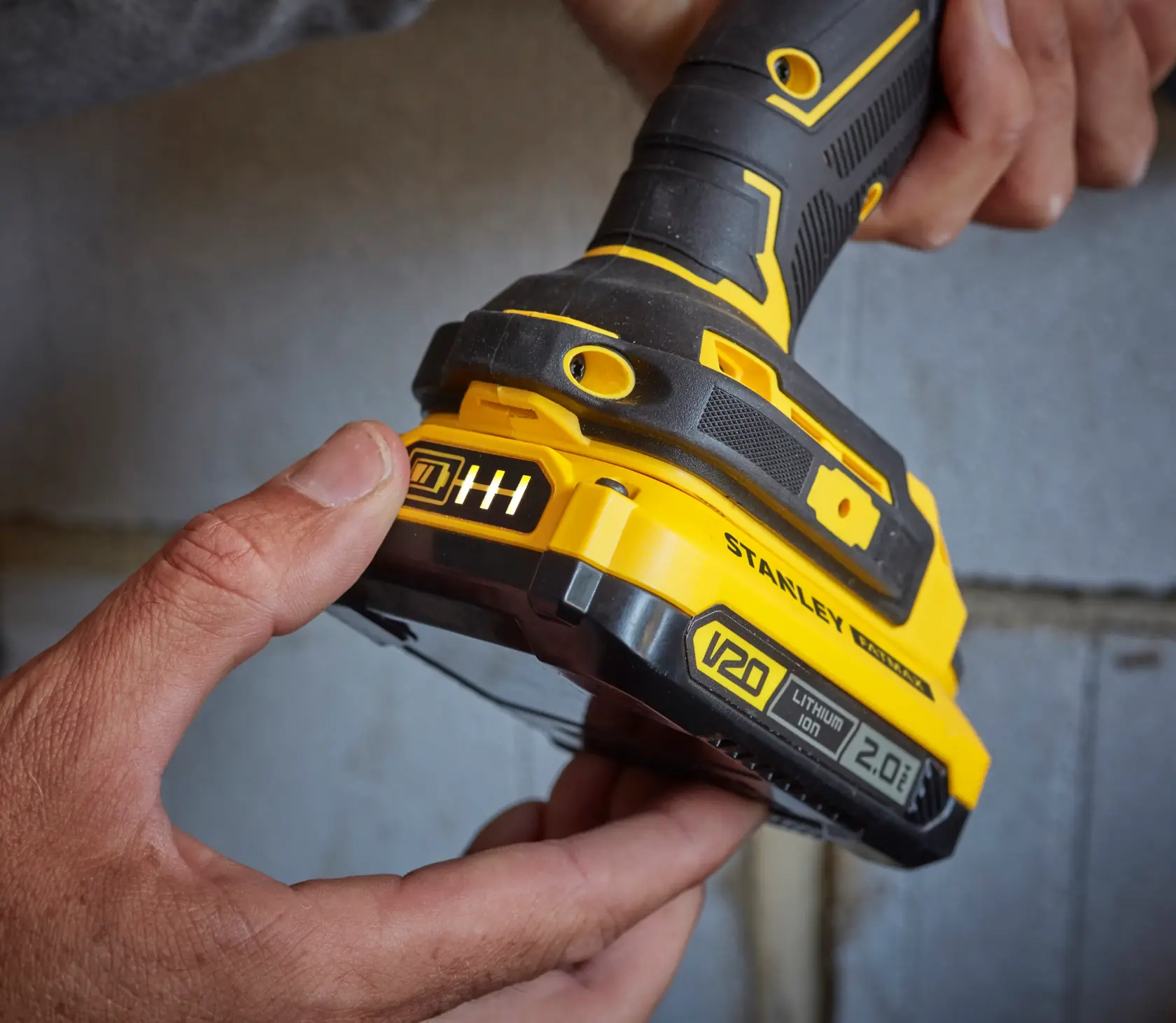 Photo of STANLEY SFMCD721B cordless drill handle and V20 2.0Ah lithium-ion battery close-up.
