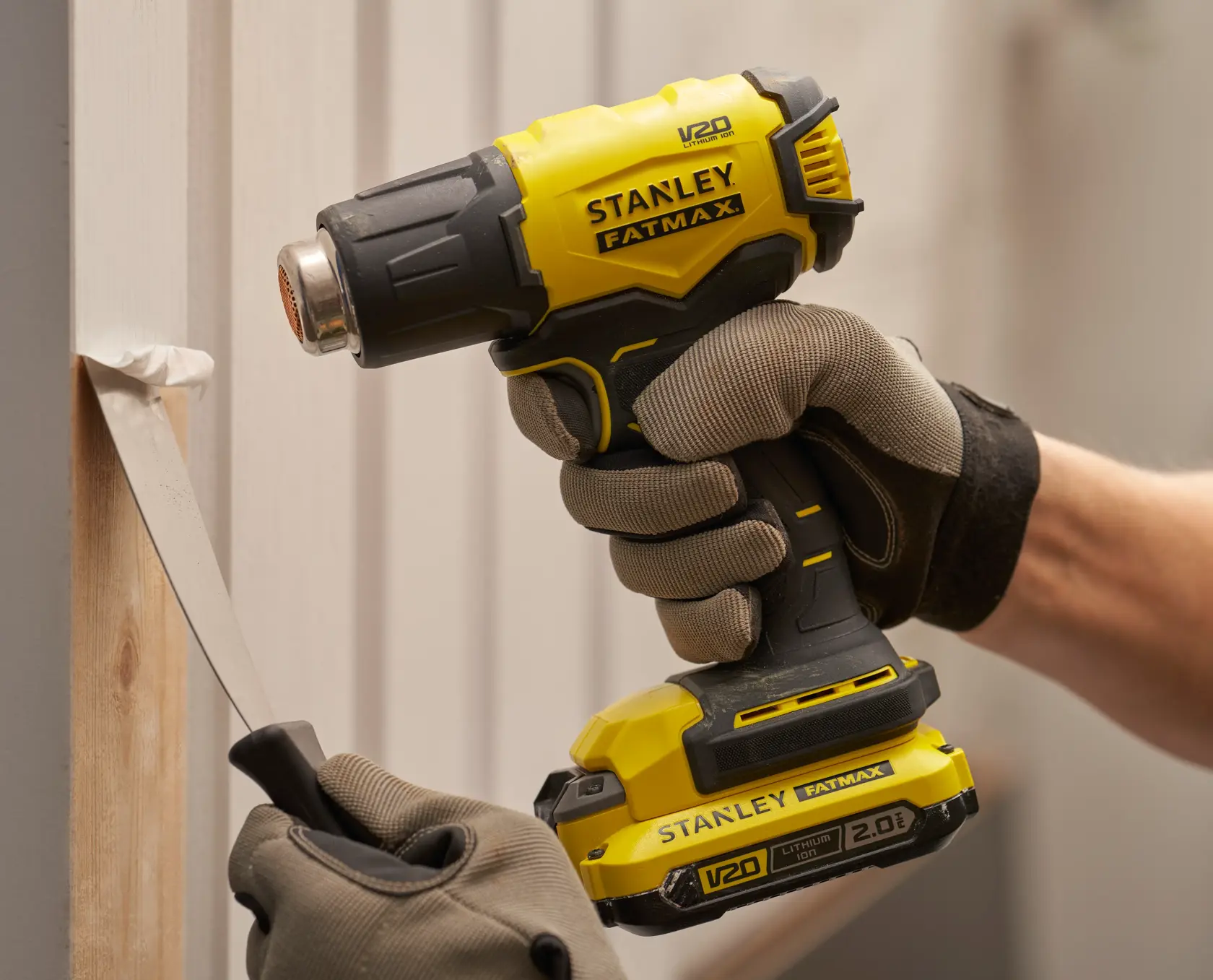 Stanley SFMCE530B heat gun used to remove paint, close-up of tool in use, photography category.