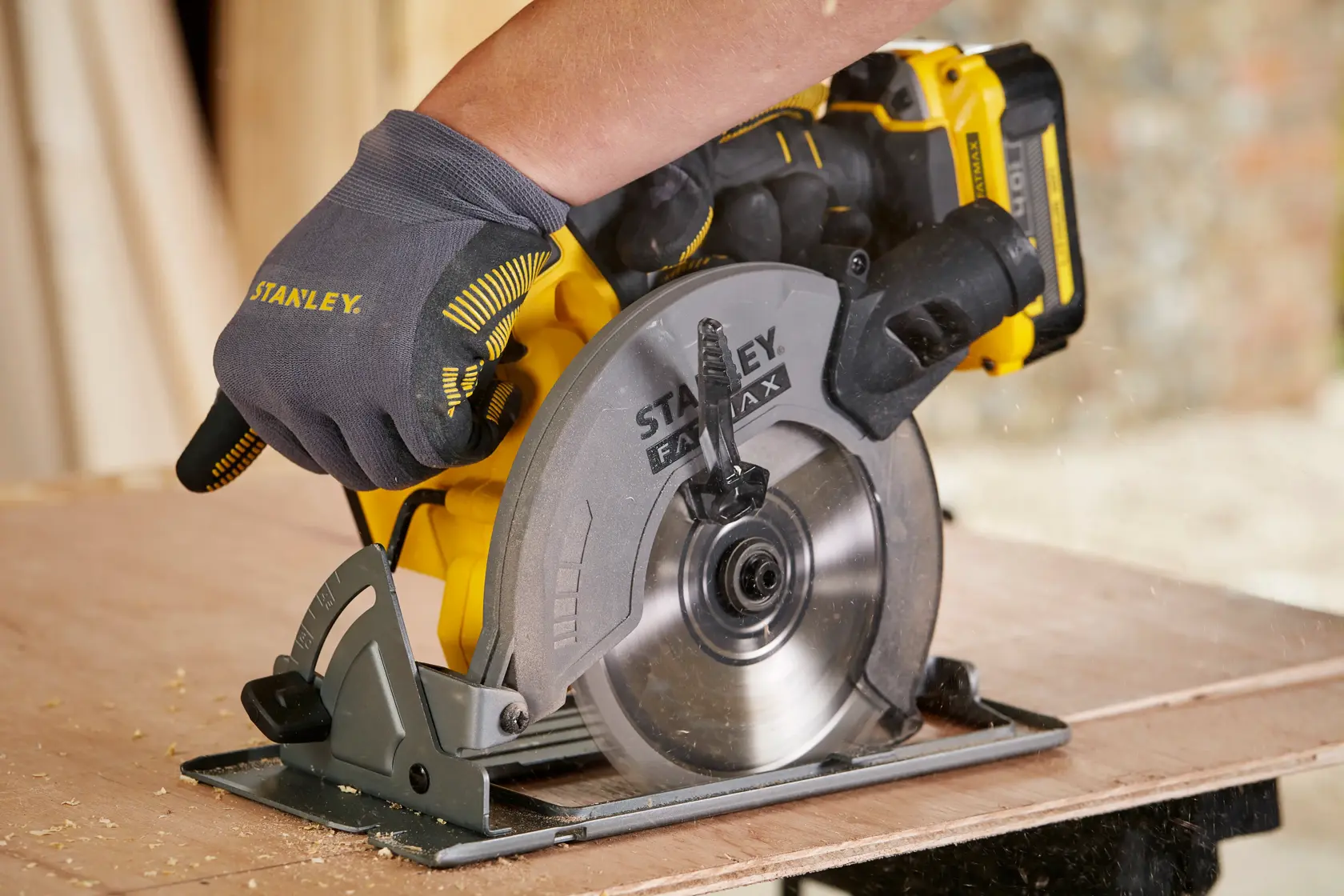 STANLEY SFMCS500M1S circular saw in use cutting wood, close-up, product photography.