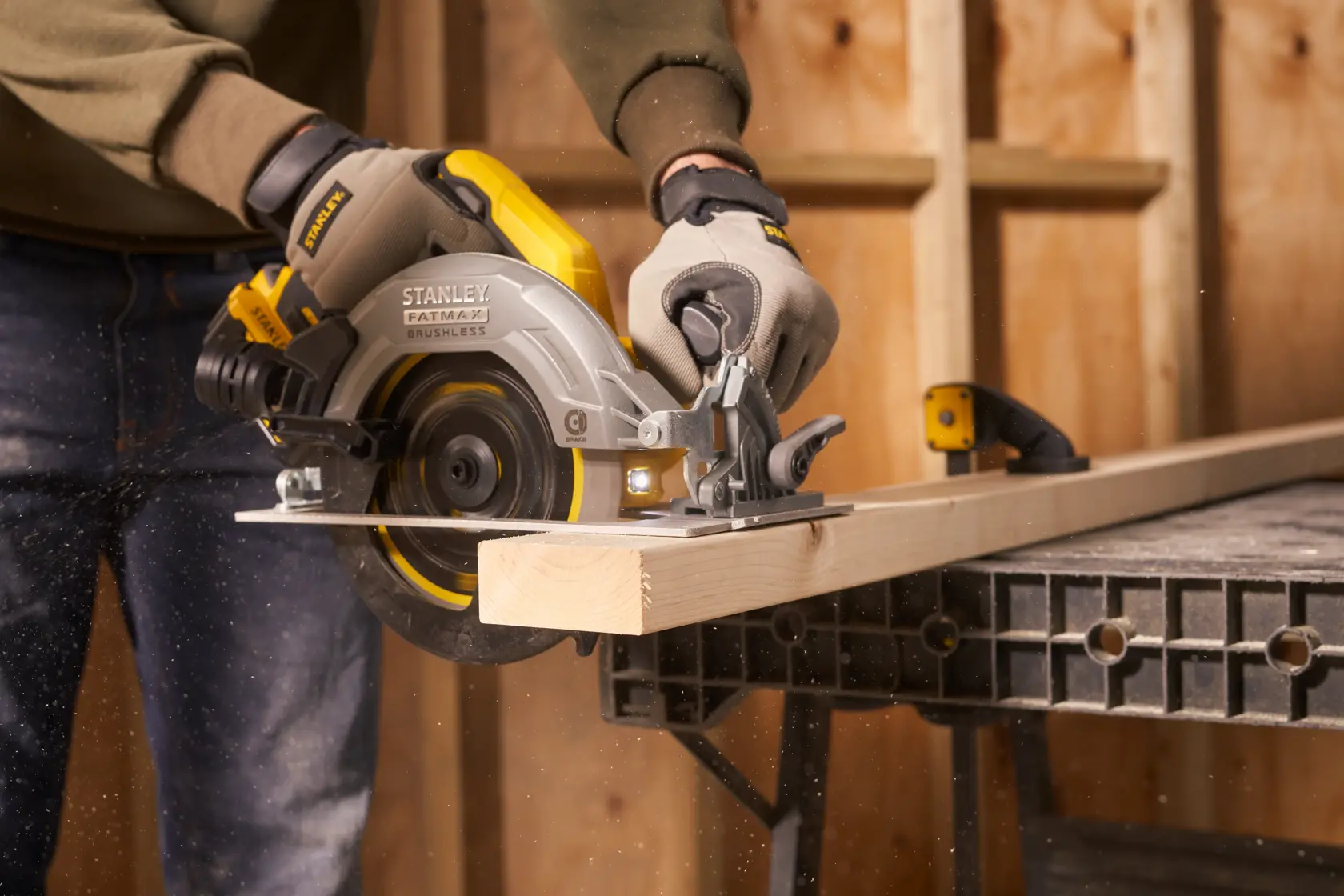 STANLEY SFMCS550B circular saw in use cutting wood, close-up in workshop setting.